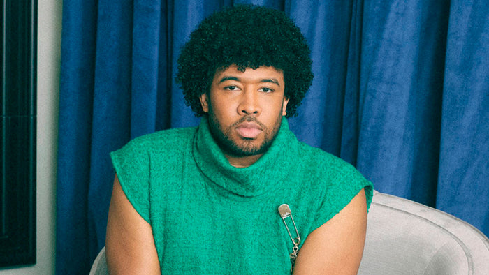 Eugene Daniels wearing green Giovanni Poncho and Pants by ORTTU